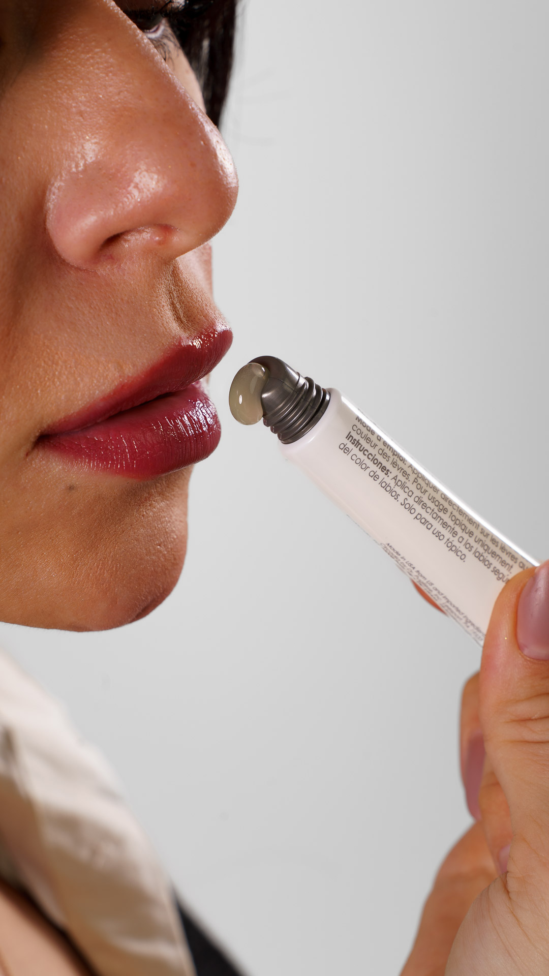 Esthetician applying a brightening serum near the cheek to target sun spots and pigmentation after summer sun exposure