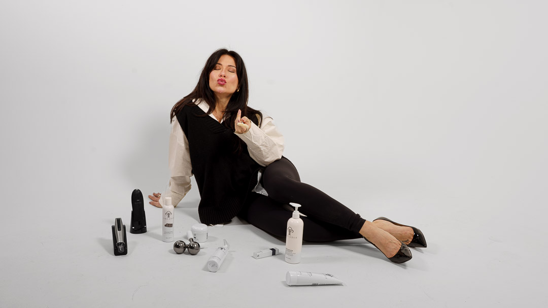Dina Telesh, founder of SkinArt Aesthetics, in the studio with skincare products