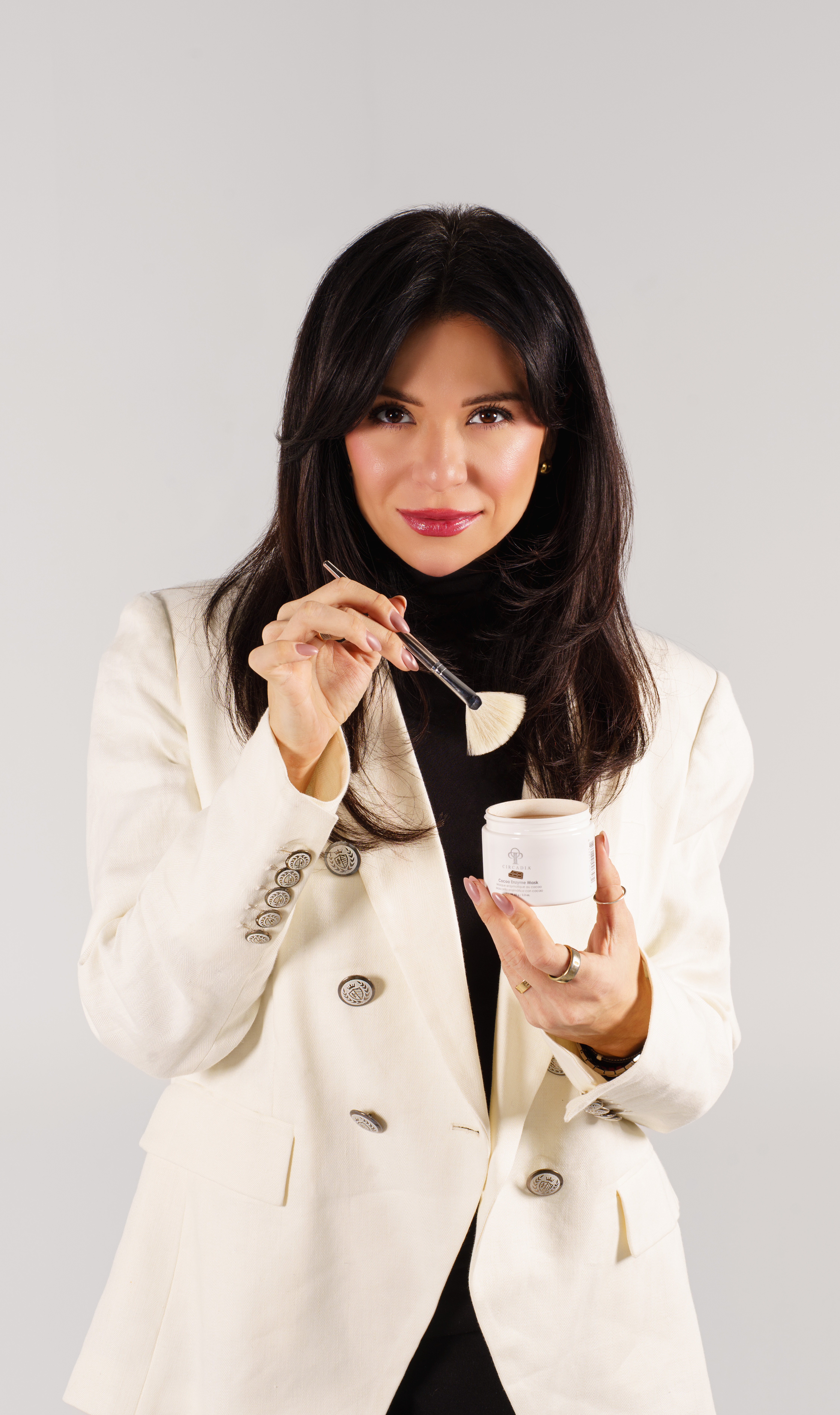 Dina, founder of Skinart Aesthetics, applying a treatment mask with a fan brush